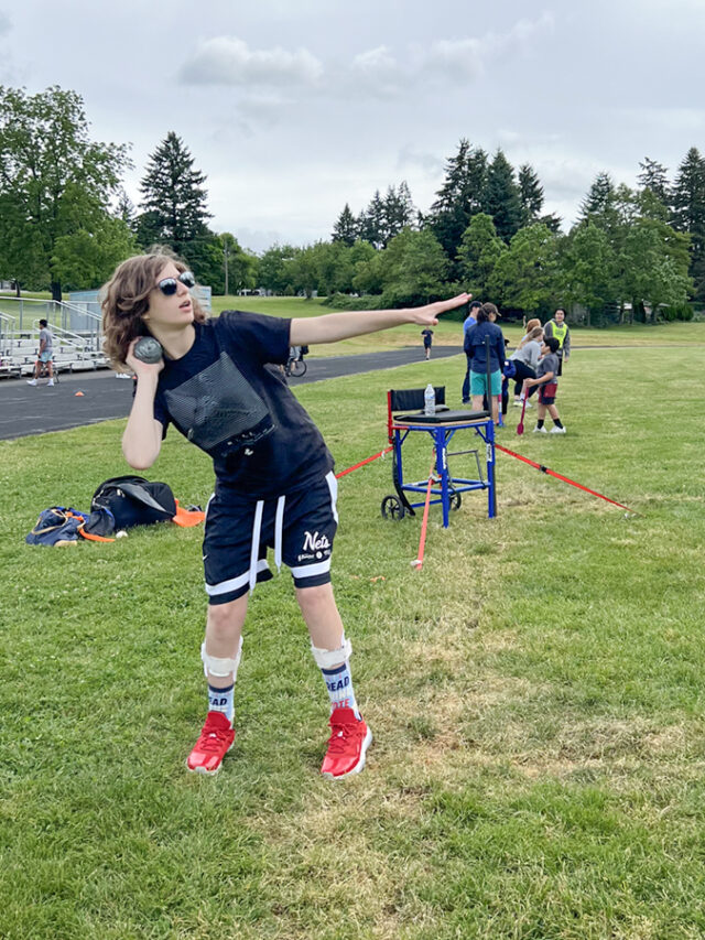 Young male athlete throwing a shootout during a field event.