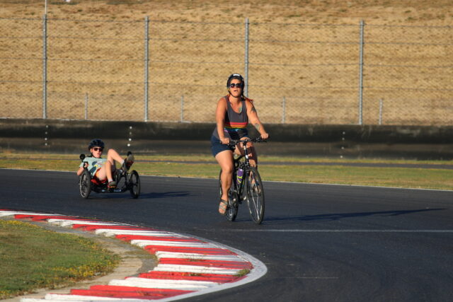 People cycling on an outdoor track.