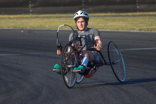 Man handcycler on a track on a sunny day,