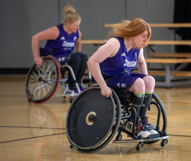Members of the PNW Reign Women's Wheelchair Basketball team in action wearing the new uniforms designed specifically for them by adidas.