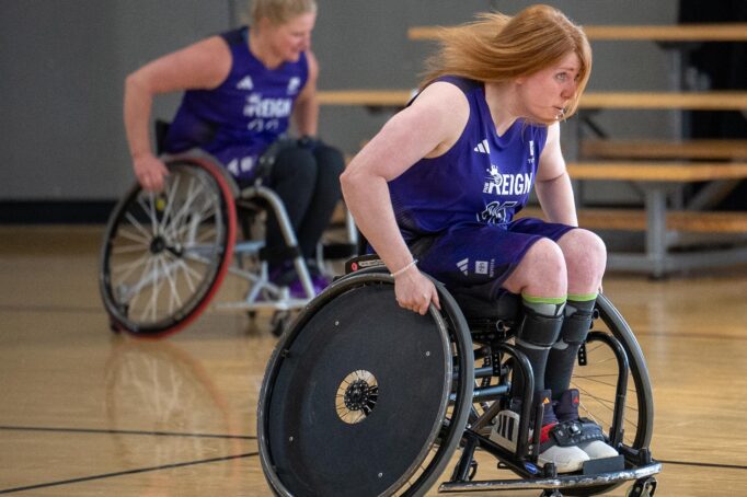 Members of the PNW Reign Women's Wheelchair Basketball team in action wearing the new uniforms designed specifically for them by adidas.