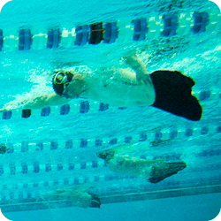 Underwater view of 3 amputees swimming in separate lanes.