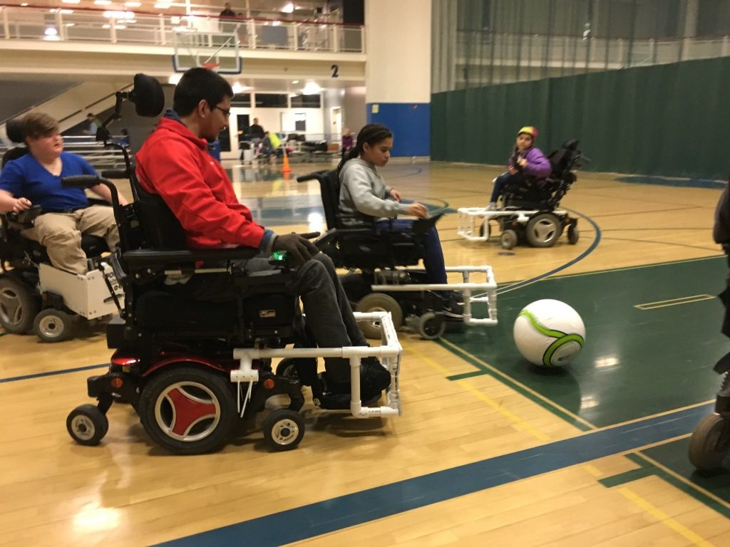 People playing power soccer on an indoor court.