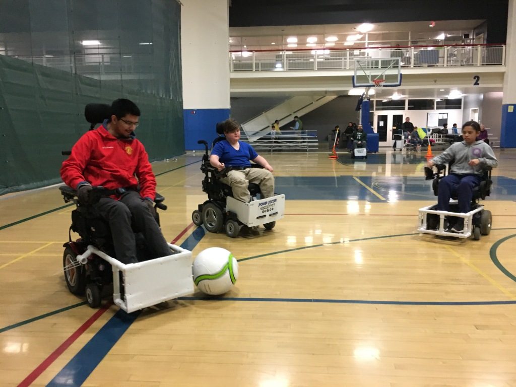 People playing power soccer on an indoor court.
